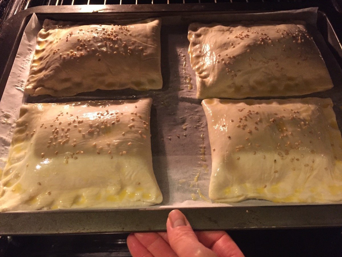 Potato Knish side dish being placed in oven